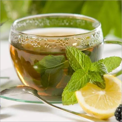 Green tea leaves in a wooden scoop